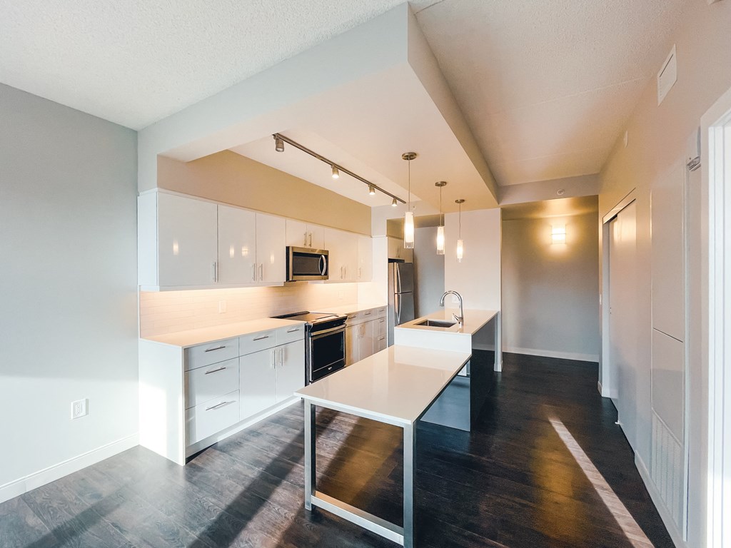 a kitchen with white cabinets and a white counter top