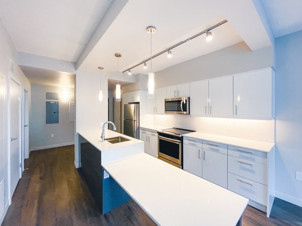 a kitchen with white cabinets and a white counter top