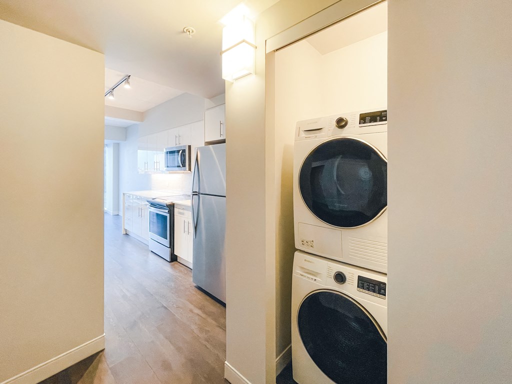 a laundry room with a washer and dryer and a kitchen