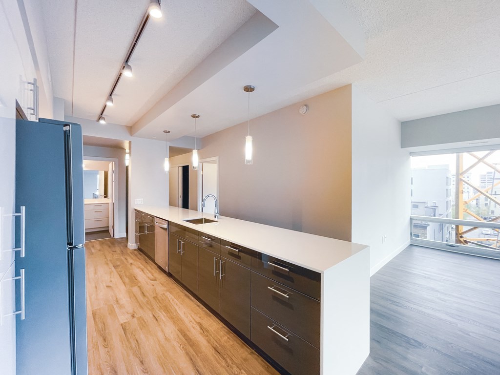 a kitchen with a large island and wood floors