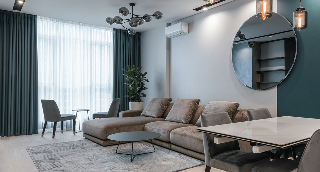 a living room with a brown couch and a large window