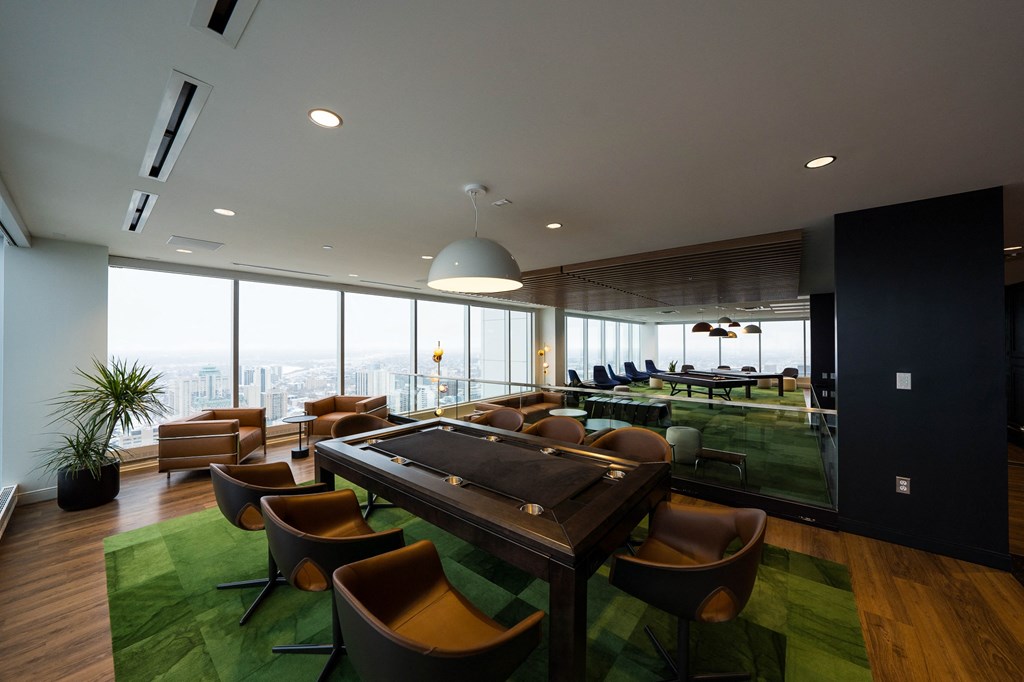 a room with a table and chairs and a view of the city