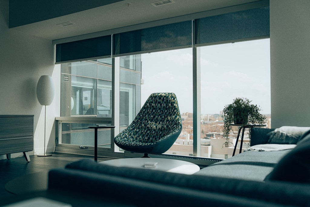 a chair in front of a window in a living room