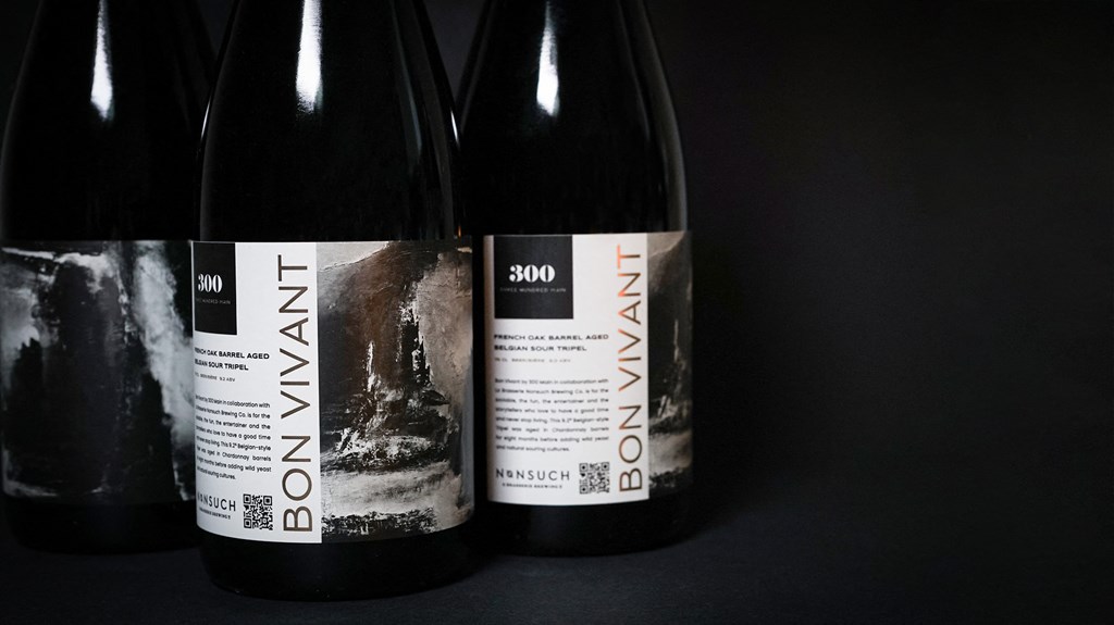 two bottles of wine against a black background