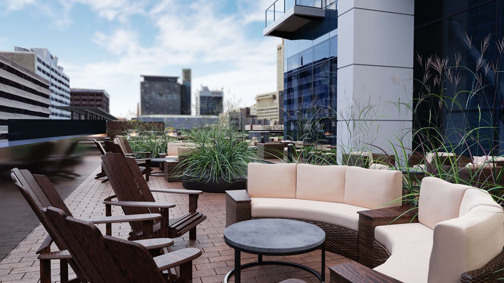 a terrace with couches and chairs on the roof of a building