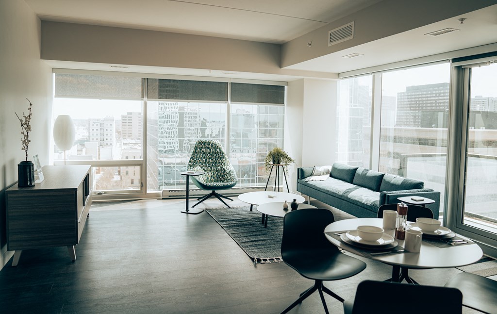 a living room with a large window and a view of the city