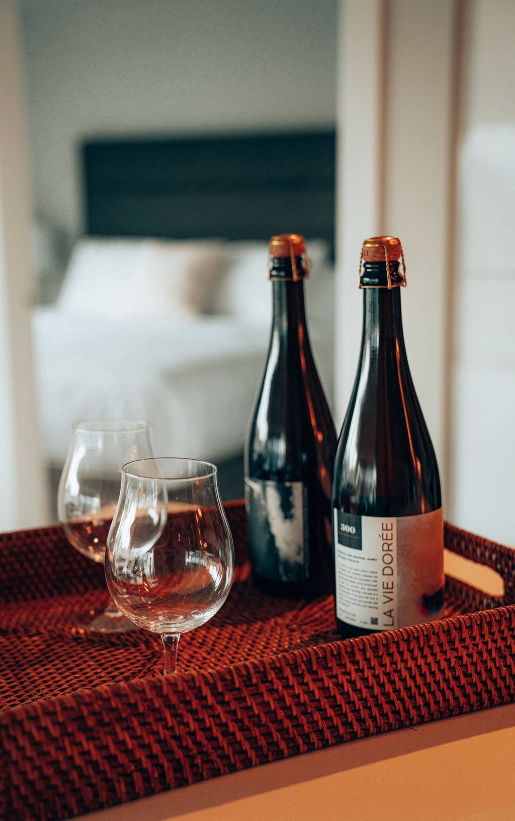 two bottles of wine and a glass on a table