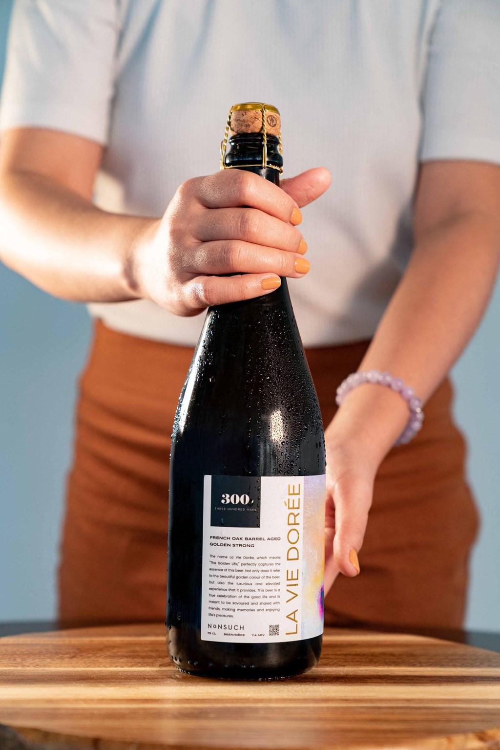 a woman holding a bottle of wine