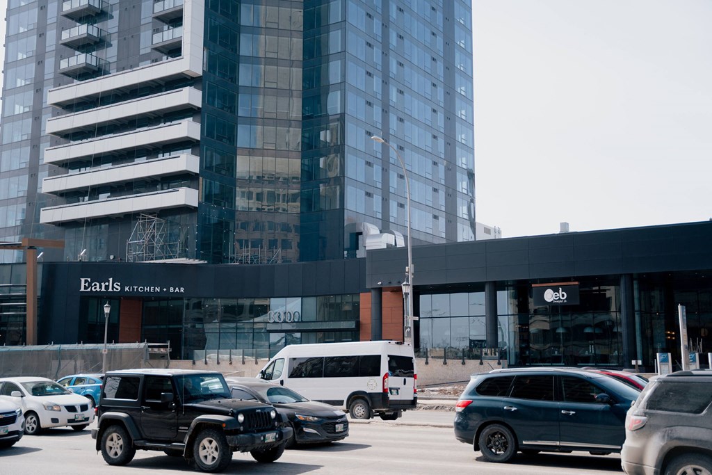 a parking lot in front of a tall building