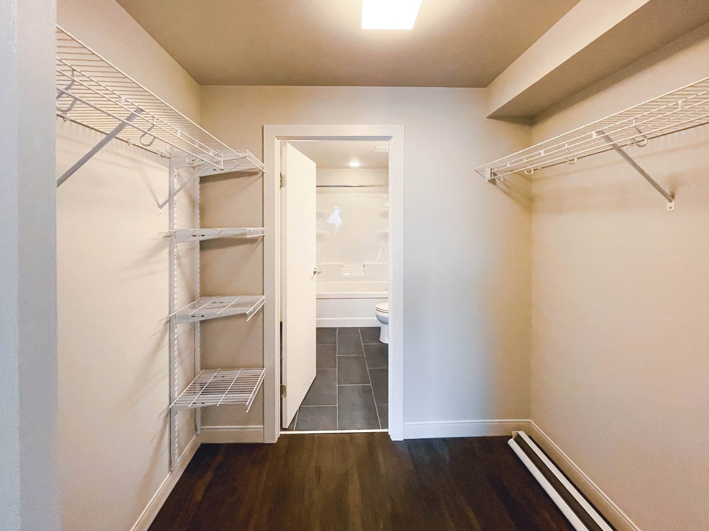 a bedroom with a medium sized bed and a mirror