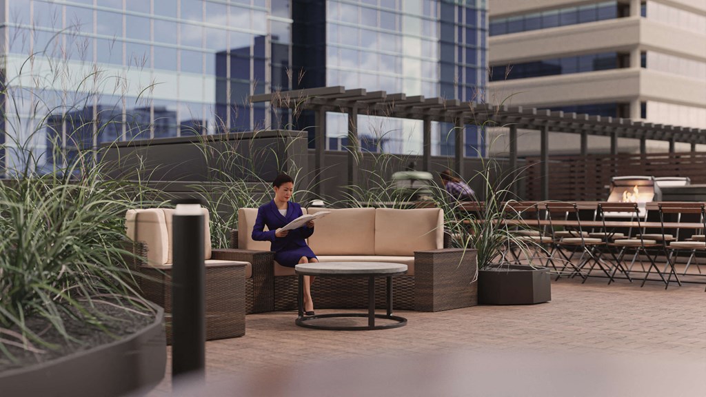 a woman sitting on a couch in an outdoor patio