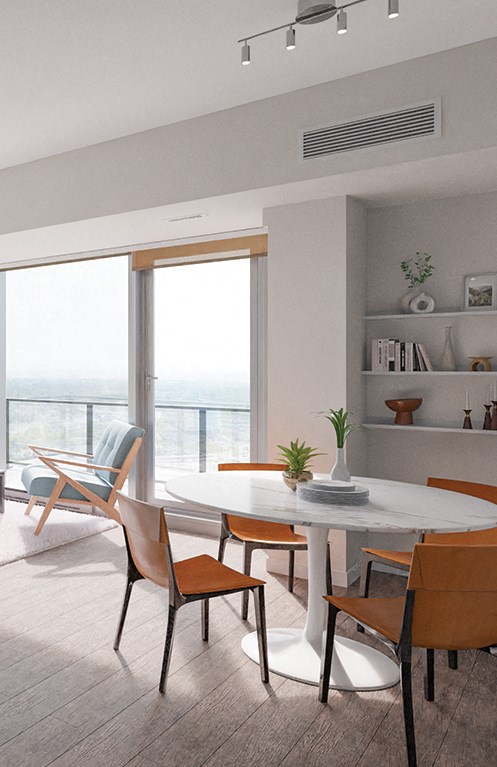 a dining room with a table and chairs and a view of the ocean