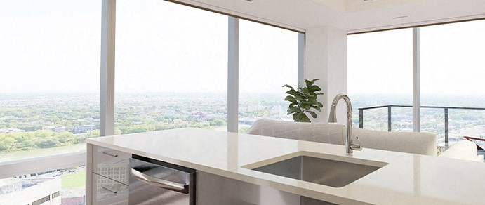 a kitchen with a sink and a view of the city