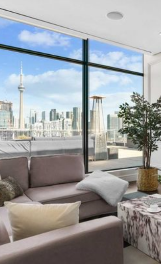a living room with a couch and a view of the city