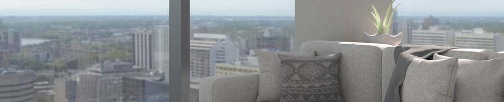 a living room with a chair and a window overlooking a city