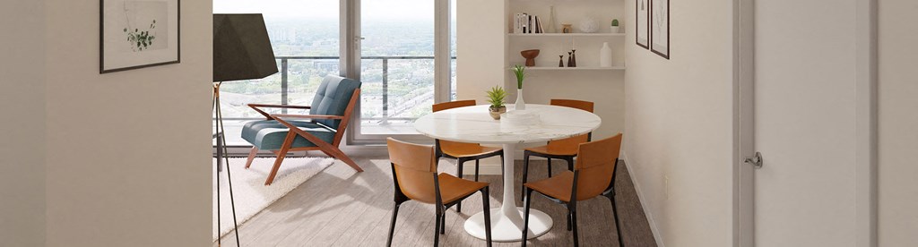 a dining room with a table and chairs and a balcony