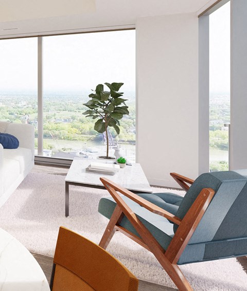 a living room with a blue chair and a white table