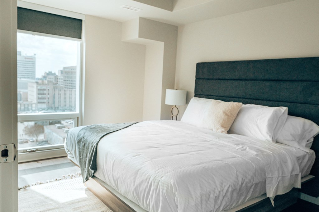 a bedroom with a large bed and a large window