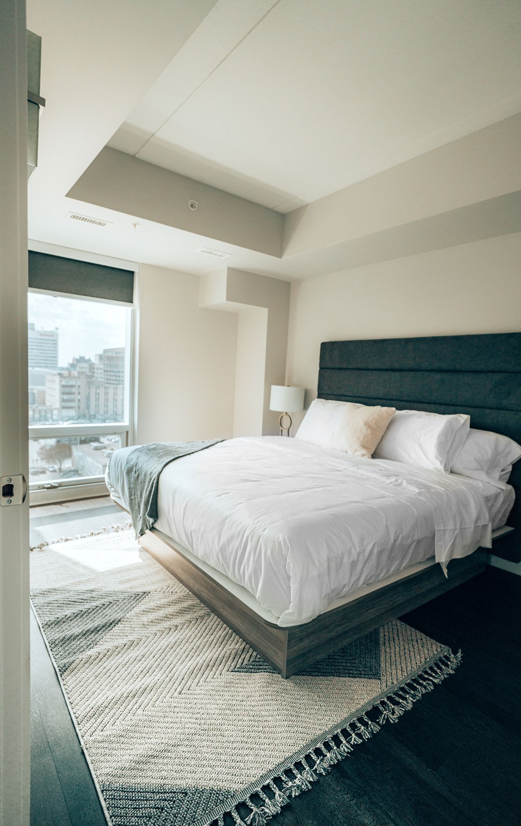 a bedroom with a large bed and a large window