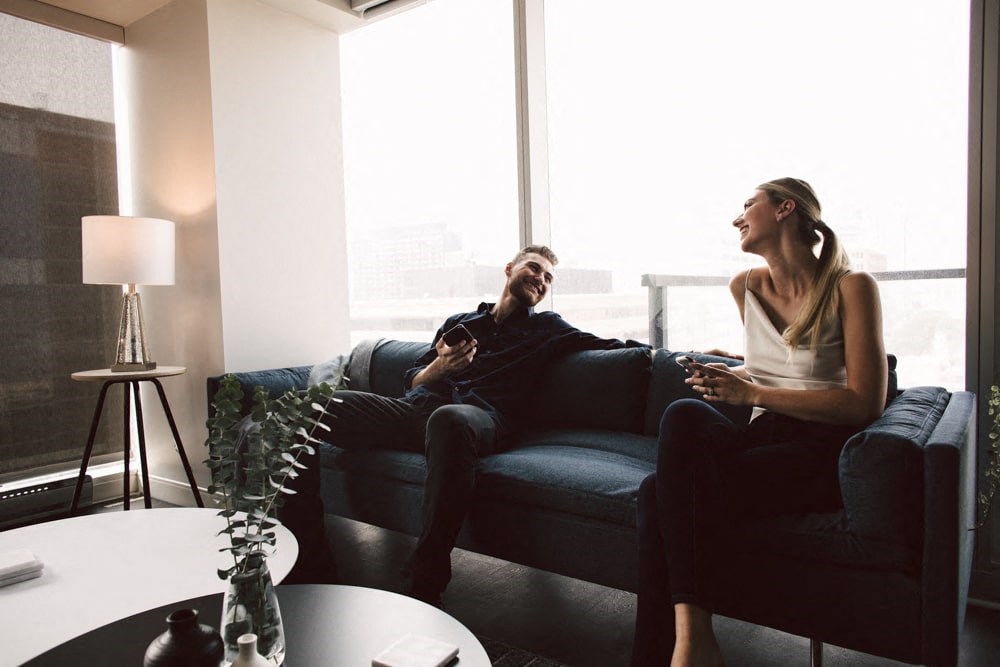 a couple sitting on a couch in a living room