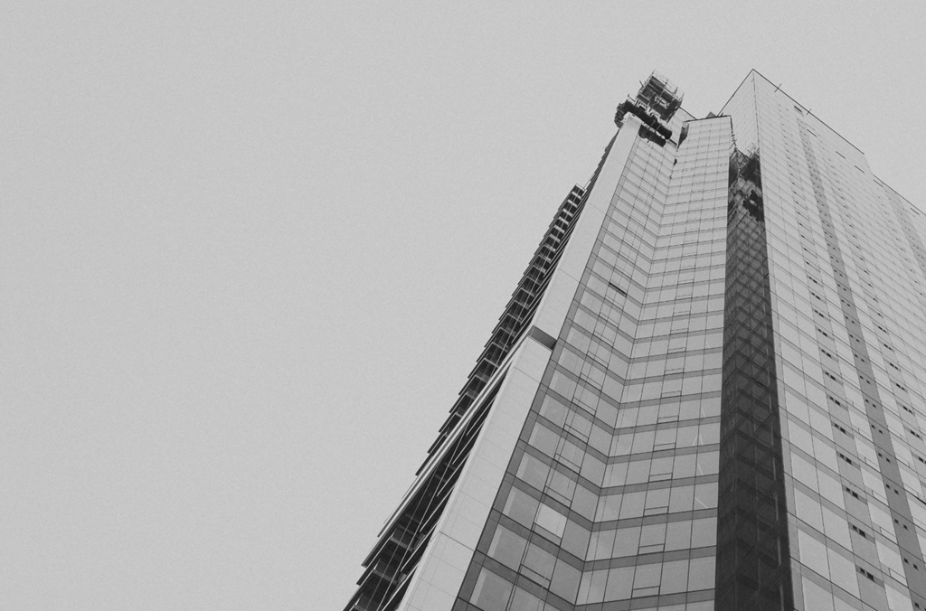a tall building with a crane on the side of it