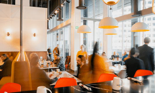 people sitting at tables in a restaurant