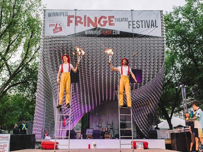 a couple of people standing on top of a ladder