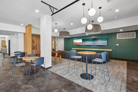 A modern dining area with a wooden table and blue chairs.