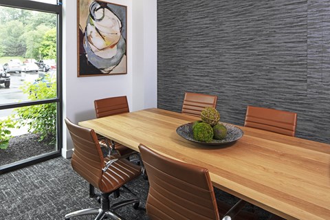 a dining room with a wooden table and chairs