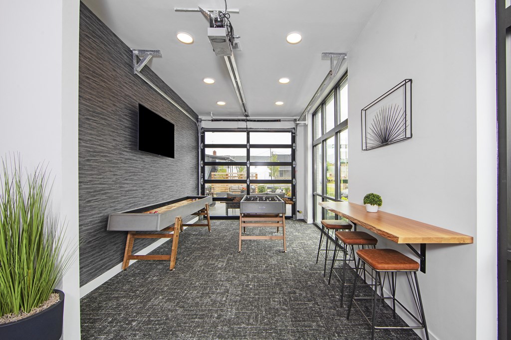 an open office space with tables and chairs and a large window