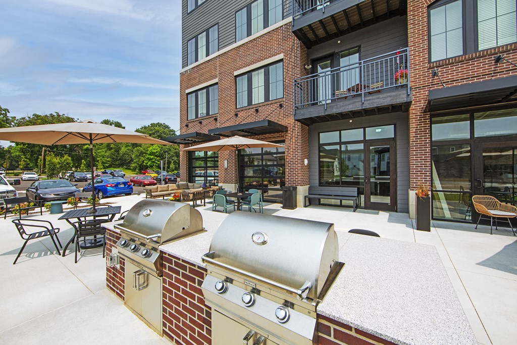 our apartments have a large outdoor patio with a grill and tables