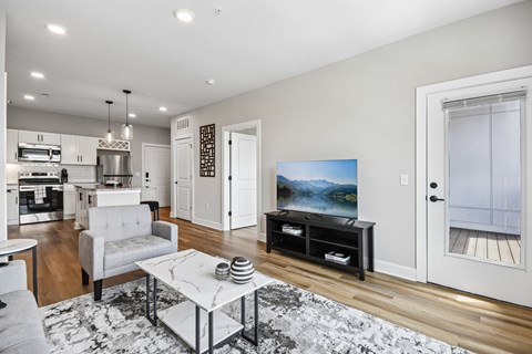 A modern living room with a grey sofa and a coffee table.