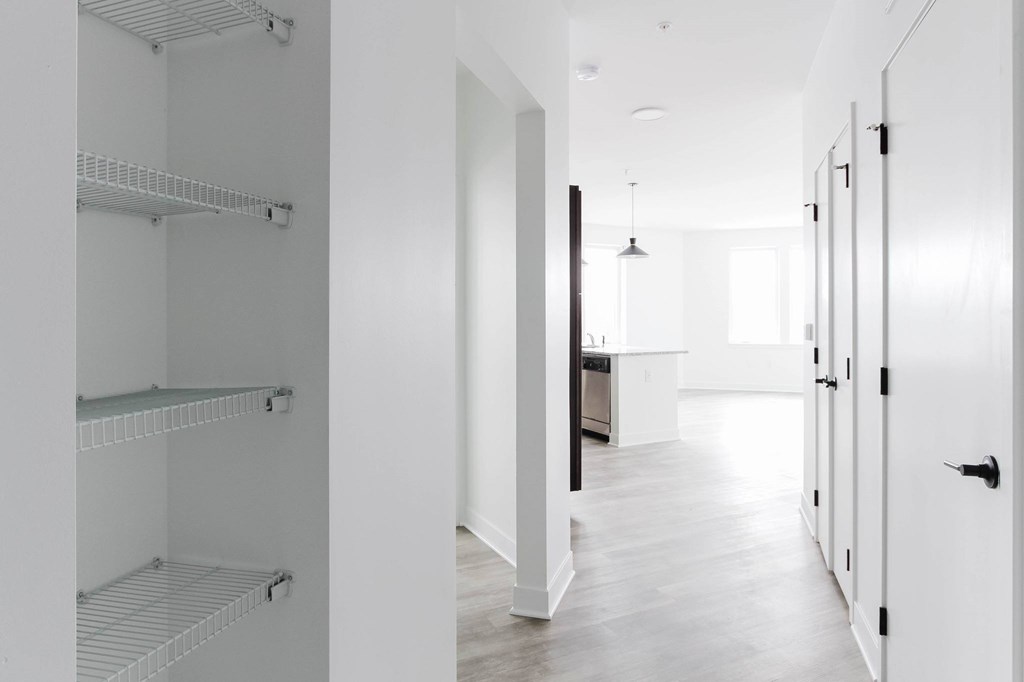 A white hallway with a door on the right.