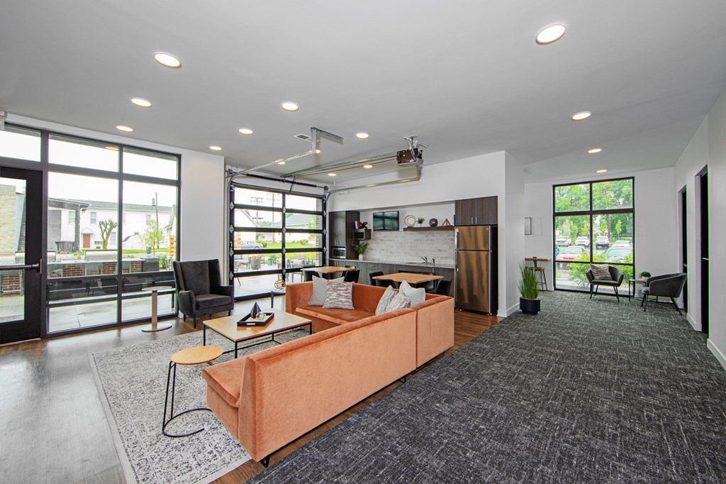 A living room with a large couch and a chair.