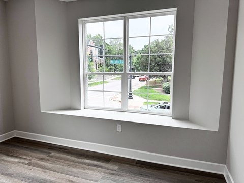 A room with a window overlooking a street.
