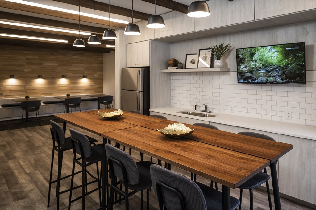 a kitchen and dining room with a wooden table