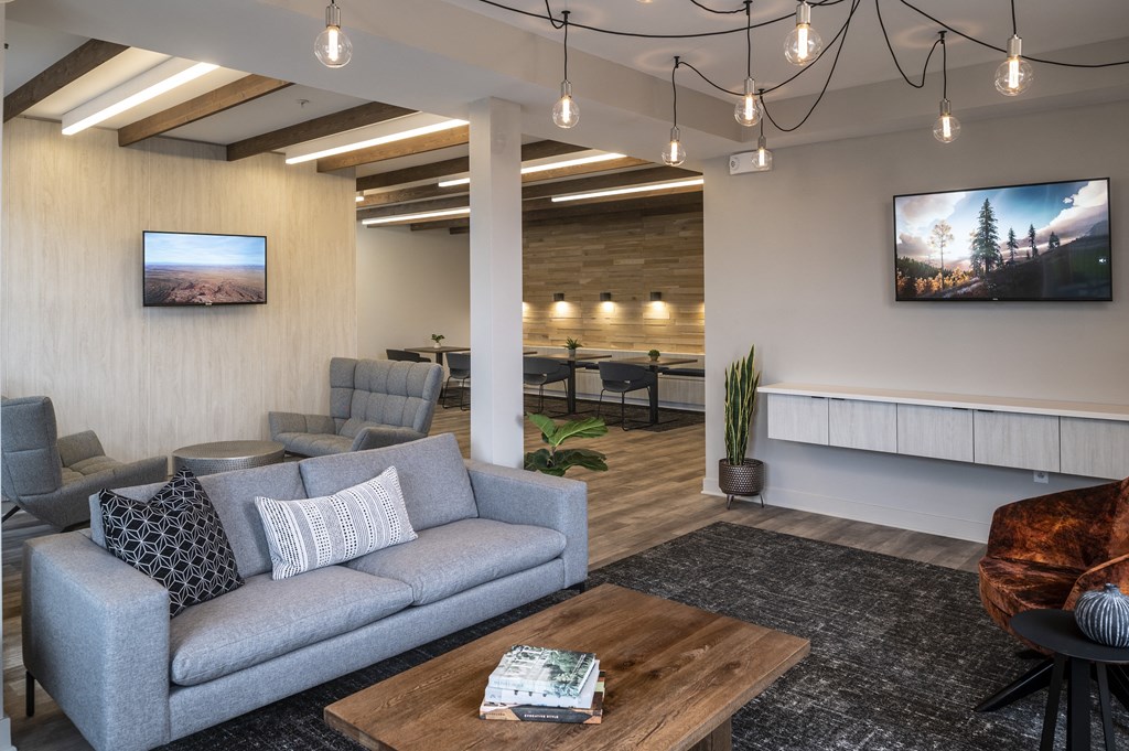 a living room with couches and chairs and a table