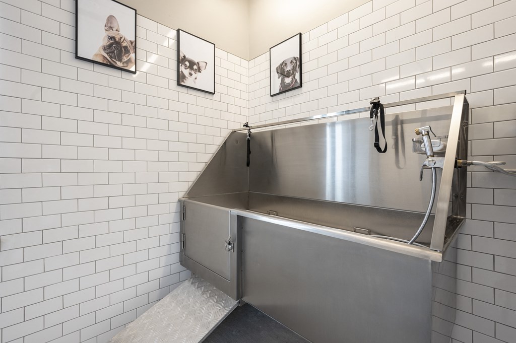 a stainless steel bathroom with a shower and a sink