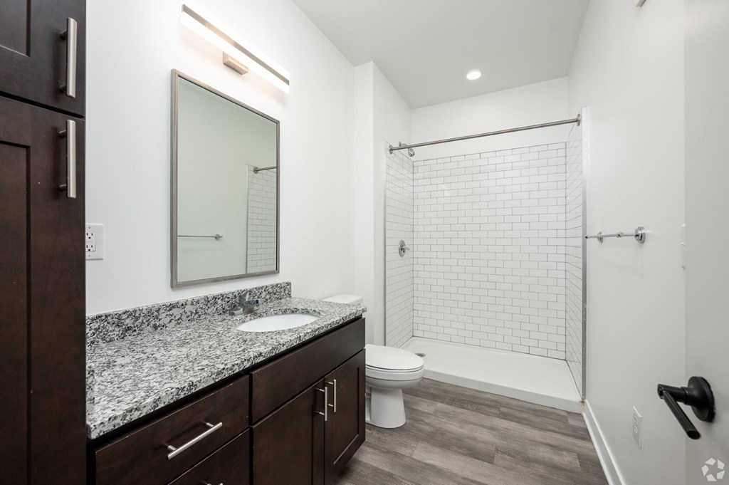 A bathroom with a white sink and a white toilet.