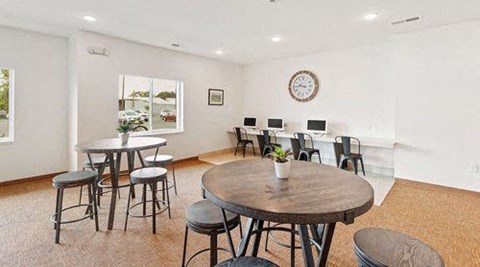a living room with a table and chairs
