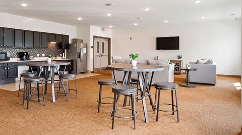 A modern kitchen with a dining table and chairs.