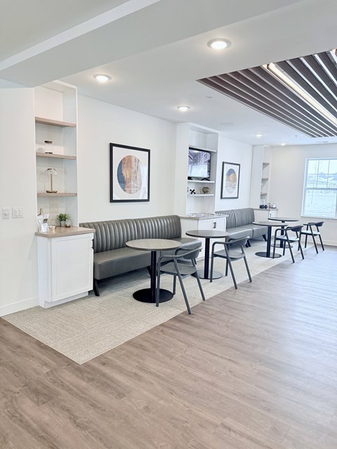 A modern living room with a grey sofa and a white cabinet.