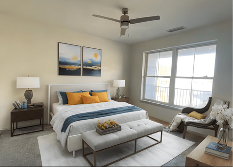 A bedroom with a bed, a chair, and a painting on the wall.