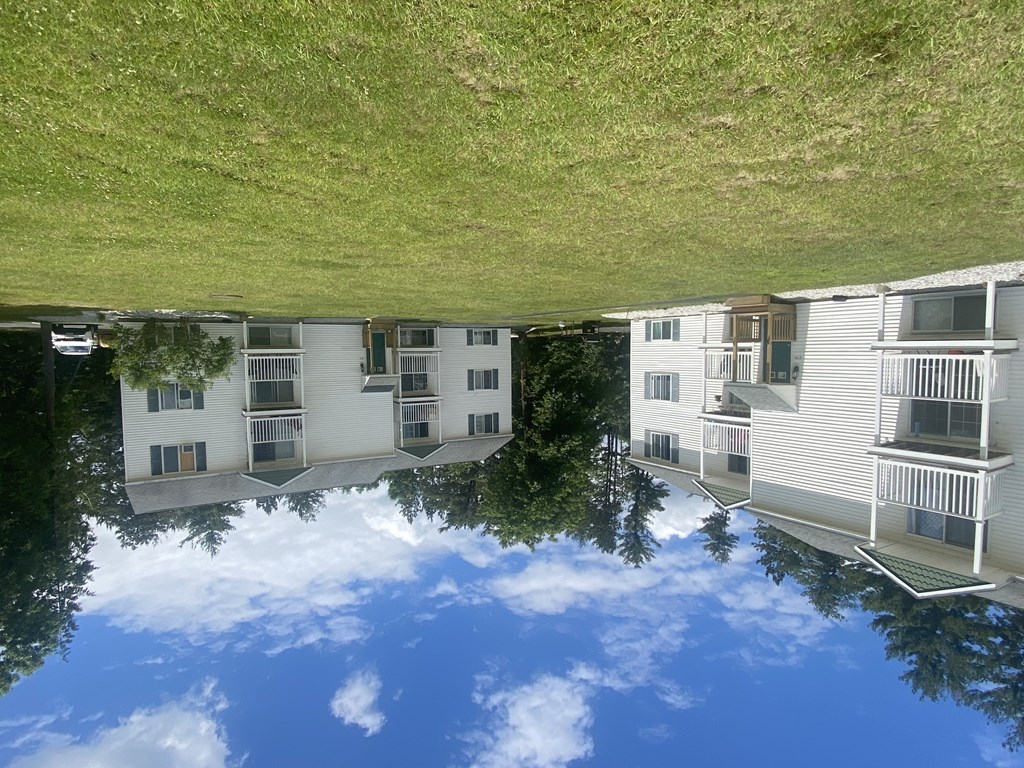 the reflection of an apartment building in the water