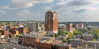 an aerial view of a city with a tall building