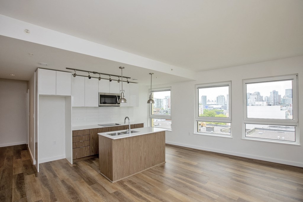 an empty kitchen with a large island in the middle