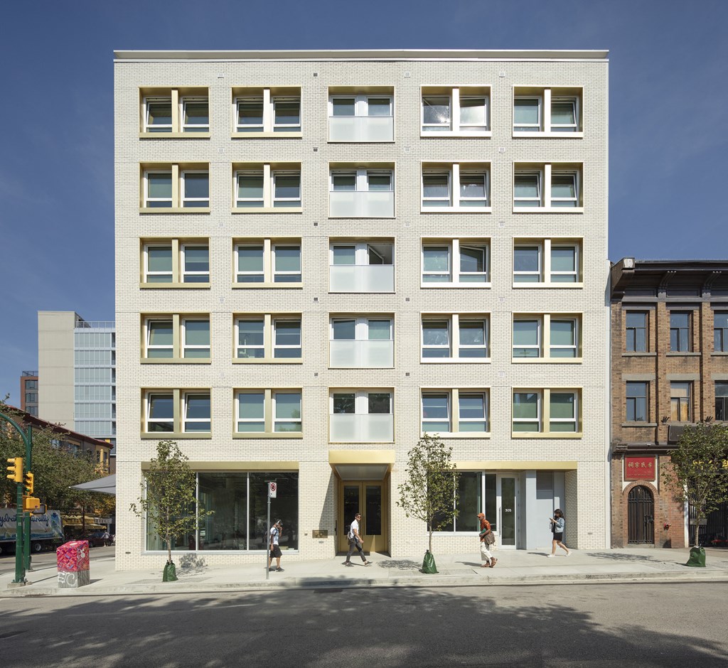 a tall brick building with a street in front of it