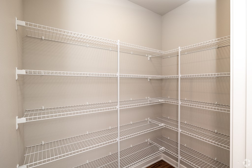 Empty white shelves in a room.