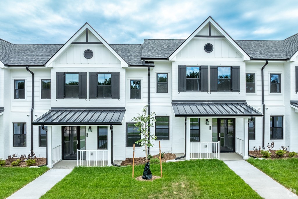 A white house with black roof and windows.