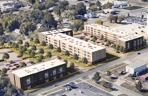 A large building complex with a parking lot in front.